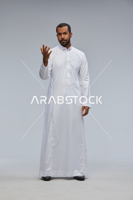 Saudi Man in White Thobe Gesturing in Studio Portrait