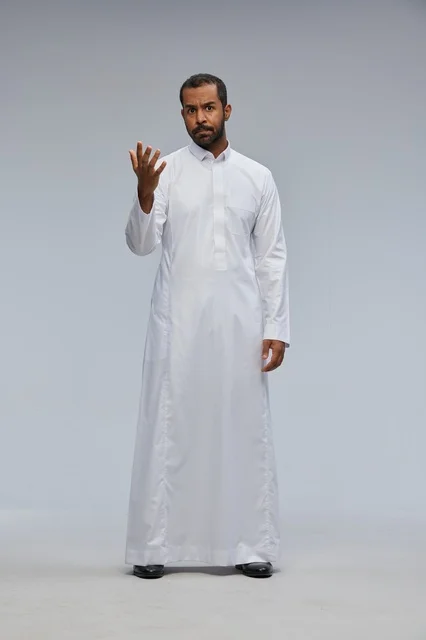 Saudi Man in White Thobe Gesturing in Studio Portrait