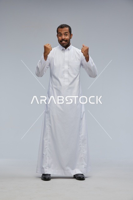 Saudi Man in White Thobe Celebrating in Studio
