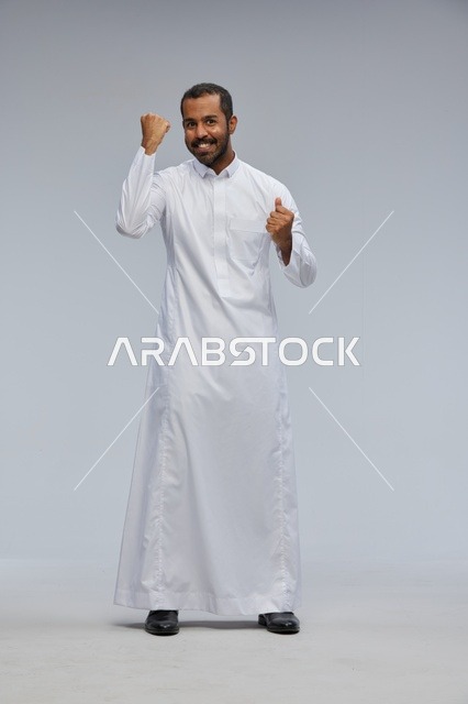 Saudi Man in White Thobe Celebrating Success Studio Shot