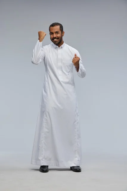 Saudi Man in White Thobe Celebrating Success Studio Shot