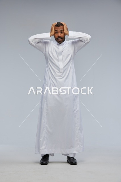 Shocked Saudi Man in White Thobe on Grey Background
