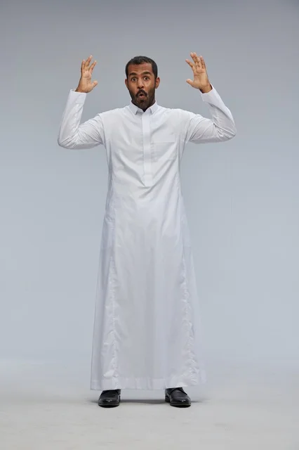 Shocked Saudi Man in White Thobe on Grey Background