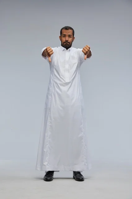 Saudi Man in White Thobe Giving Double Thumbs Down