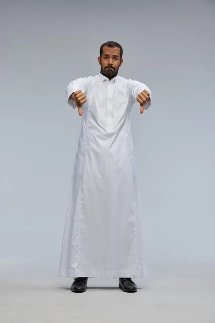 Saudi Man in White Thobe Giving Thumbs Down Disapproval