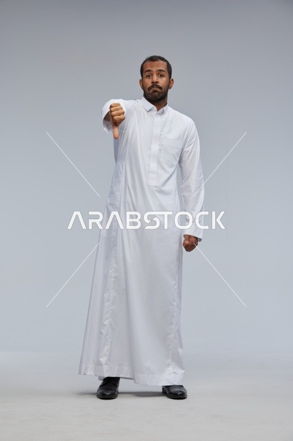 Saudi Man in White Thobe Giving Thumbs Down Gesture