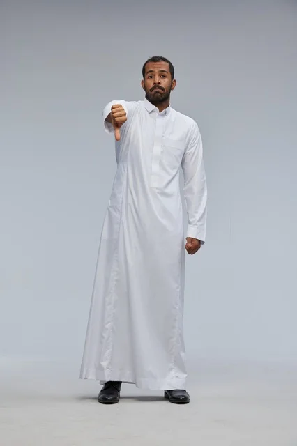 Saudi Man in White Thobe Giving Thumbs Down Gesture