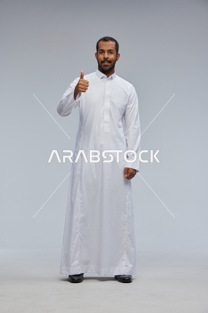 Saudi Man in White Thobe Giving Thumbs Up in Studio