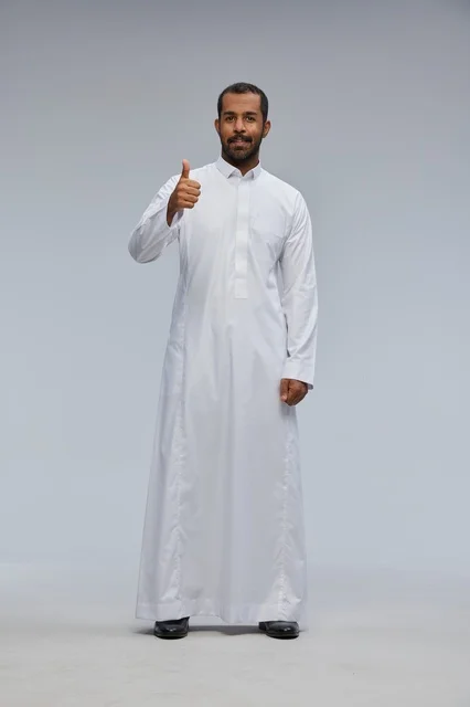 Saudi Man in White Thobe Giving Thumbs Up in Studio