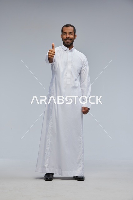 Saudi Man in White Thobe Giving Thumbs Up in Studio