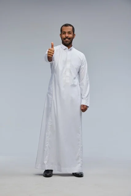Saudi Man in White Thobe Giving Thumbs Up in Studio