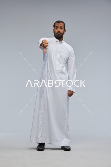Saudi Man in Thobe Giving Thumbs Down in Studio