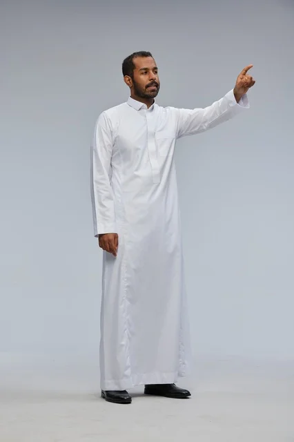 Saudi Man in White Thobe Pointing at Virtual Interface