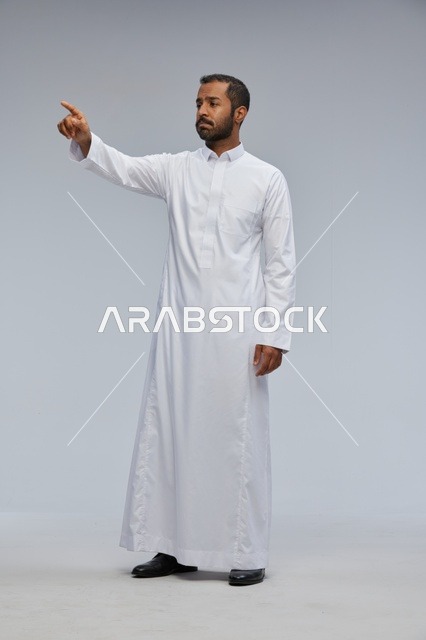 Saudi Man in White Thobe Pointing in Studio