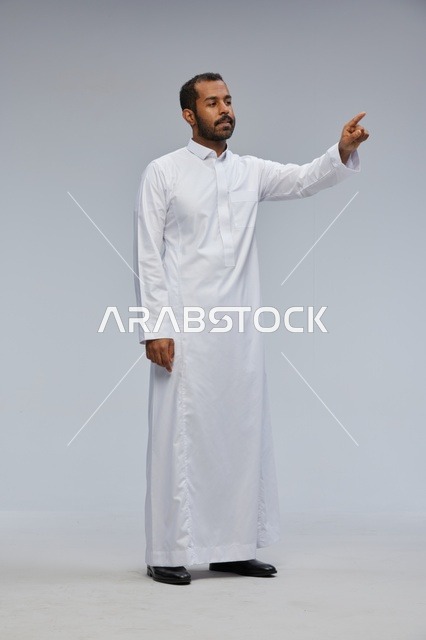 Saudi Man in White Thobe Pointing in Studio