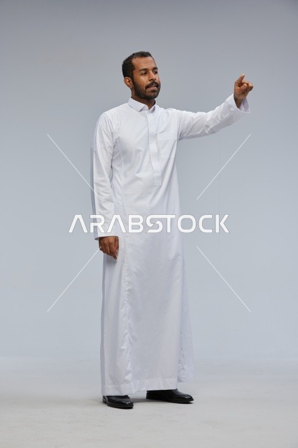 Saudi Man in White Thobe Pointing in Studio