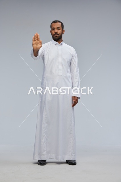 Saudi Man in White Thobe Making Stop Gesture in Studio