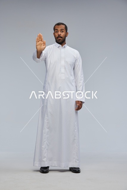 Saudi Man in White Thobe Making Stop Gesture in Studio