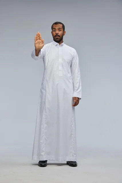 Saudi Man in White Thobe Making Stop Gesture in Studio