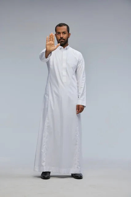 Saudi Man in White Thobe Making Stop Gesture