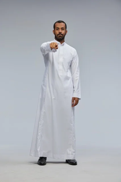 Saudi Man in White Thobe Pointing at Camera