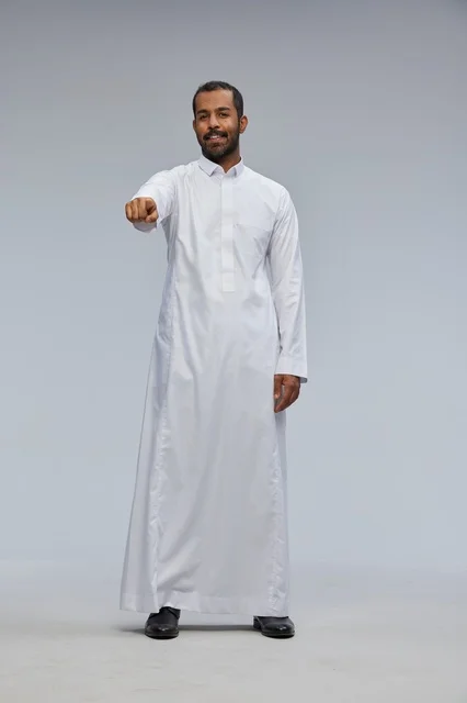 Saudi Man in White Thobe Pointing at Camera