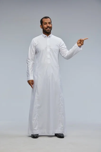 Saudi Man in White Thobe Pointing on Grey Background