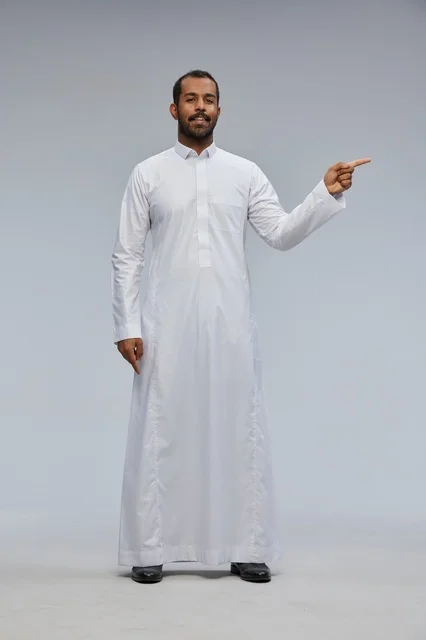 Saudi Man in White Thobe Pointing Side in Studio