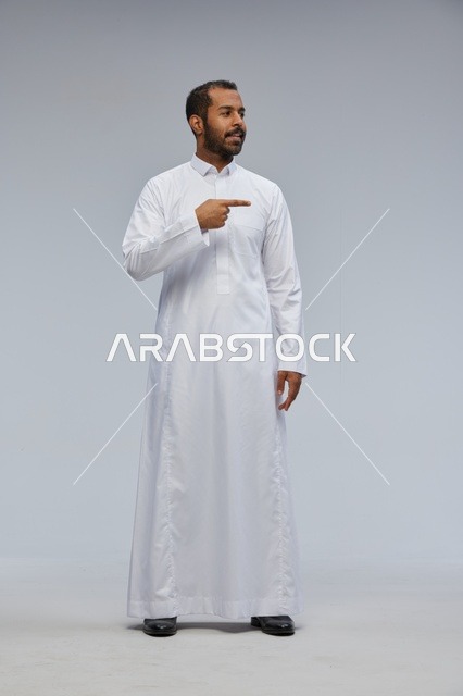 Saudi Man in White Thobe Pointing in Studio