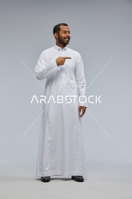 Saudi Man in White Thobe Pointing Side Studio Portrait