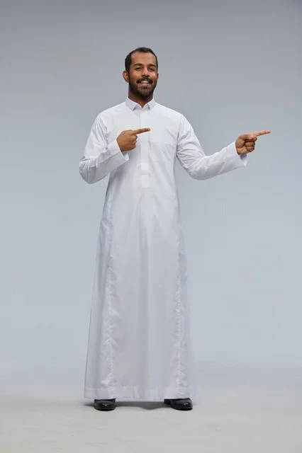 Saudi Man in White Thobe Pointing Side in Studio