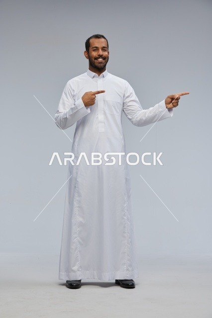 Saudi Man in White Thobe Pointing in Studio
