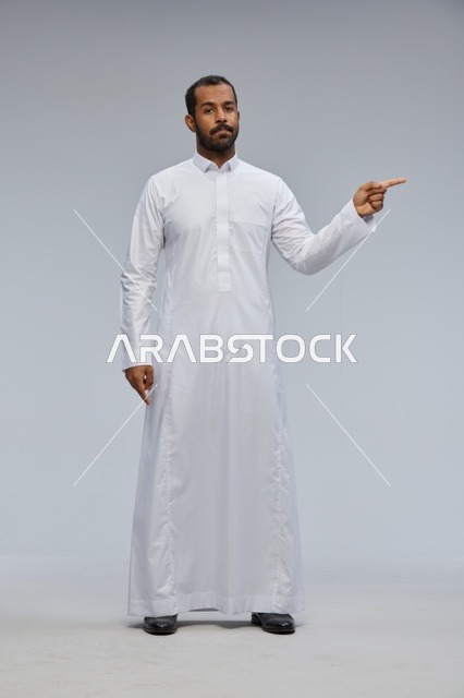 Saudi Man in White Thobe Pointing Finger in Studio