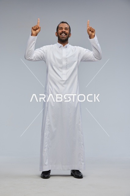 Saudi Man in White Thobe Pointing Up in Studio