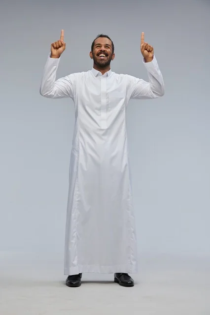 Saudi Man in White Thobe Pointing Up in Studio