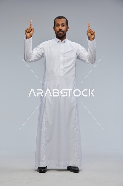 Saudi Man in White Thobe Pointing Up in Studio
