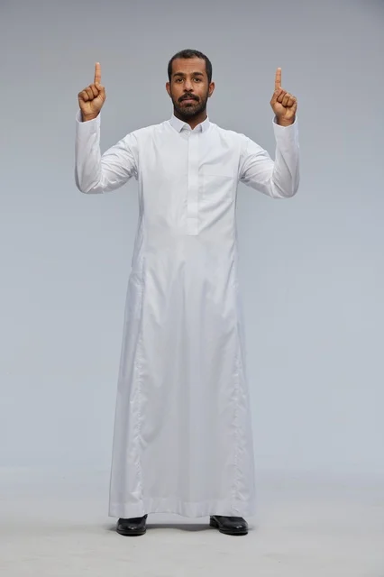 Saudi Man in White Thobe Pointing Up in Studio