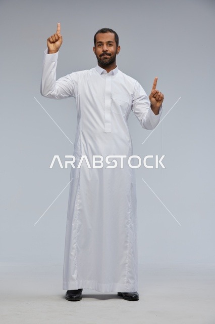 Saudi Man in White Thobe Pointing Up on Grey Background