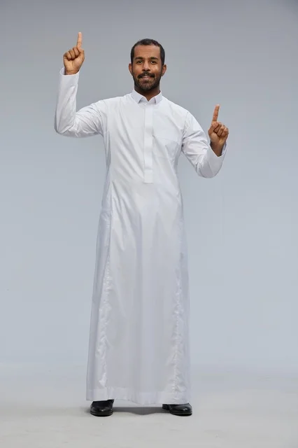 Saudi Man in White Thobe Pointing Up in Studio