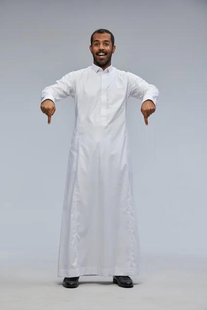 Saudi Man in White Thobe Pointing Down in Studio