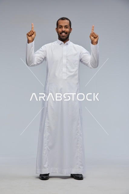 Saudi Man in Thobe Pointing Up in Studio Background