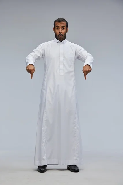 Saudi Man in White Thobe Pointing Down with Surprised Face