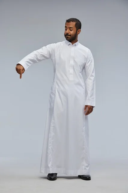 Saudi Man in White Thobe Pointing Down in Studio