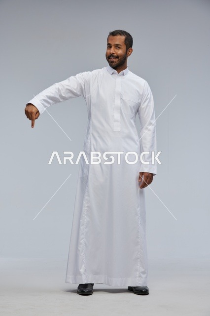 Saudi Man in White Thobe Pointing Downward Studio Shot