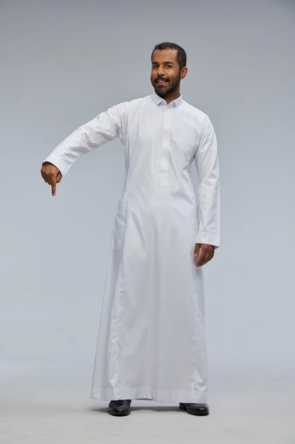 Saudi Man in White Thobe Pointing Down Studio Portrait