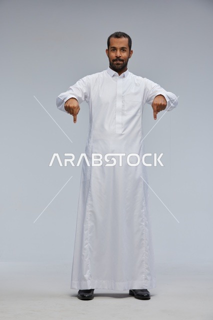 Full Length Saudi Man in White Thobe Pointing Down