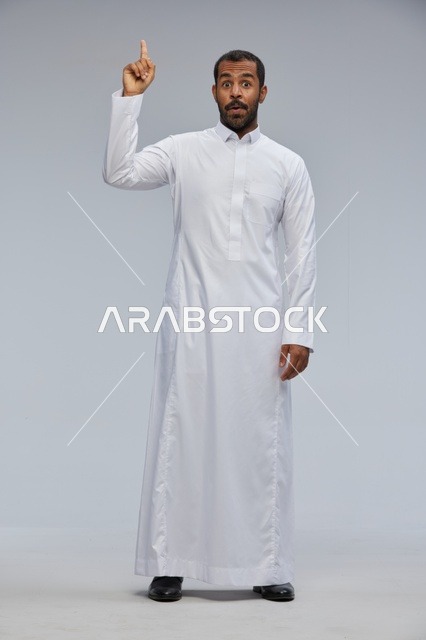 Saudi Man in White Thobe Pointing Up in Studio