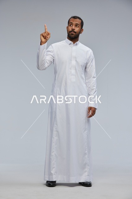 Saudi Man in White Thobe Pointing Upwards Studio Shot