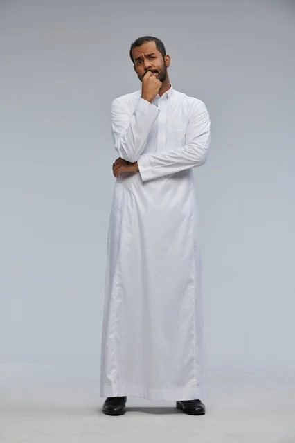 Pensive Saudi Man in White Thobe Thinking in Studio