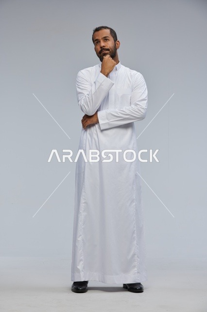 Saudi Man in White Thobe Thinking in Full Body Studio Shot